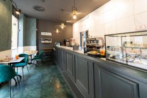 a restaurant with a counter and tables and chairs at Soho Boutique Malaga in Málaga