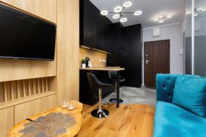 Televízia a/alebo spoločenská miestnosť v ubytovaní Apartments Warsaw Pawia by Noclegi Renters