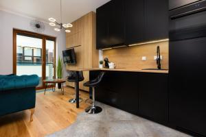Televízia a/alebo spoločenská miestnosť v ubytovaní Apartments Warsaw Pawia by Noclegi Renters