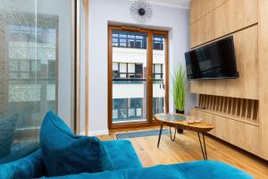 Televízia a/alebo spoločenská miestnosť v ubytovaní Apartments Warsaw Pawia by Noclegi Renters