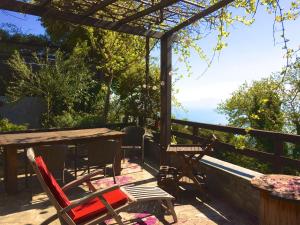 una mesa de madera y sillas en una terraza con mesa y sillas en Great Pelion Villa Villa Stone House 2 bedrooms Sea View Aghios Georgios en Pilion