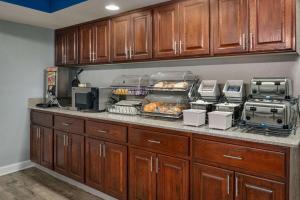 a kitchen counter with some food on it at Baymont by Wyndham Swanton in Swanton