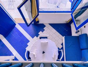 a bathroom with a white toilet in a room at Marina Cap Monastir- Appart'Hôtel in Monastir