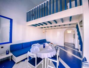 a living room with a blue couch and a table at Marina Cap Monastir- Appart'Hôtel in Monastir