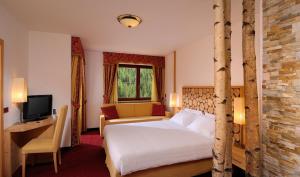 Postel nebo postele na pokoji v ubytování Hotel La Perla