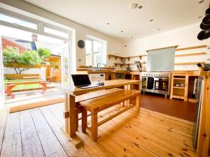 a kitchen with a laptop computer on a wooden desk at Nomi Homes - Powderham - Exeter - Uni - Free parking - Central in Exeter