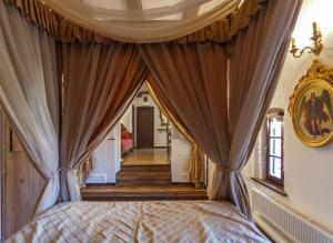 a bedroom with a bed with a canopy at БУТИК-ОТЕЛЬ «VIA REGIA» in Radomyshlʼ