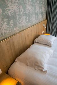 Postel nebo postele na pokoji v ubytování Hotel De Zes Bochten