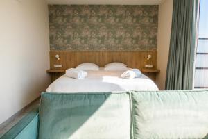 Postel nebo postele na pokoji v ubytování Hotel De Zes Bochten