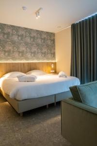 Postel nebo postele na pokoji v ubytování Hotel De Zes Bochten