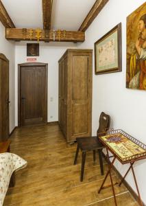 a room with a table and a painting on the wall at БУТИК-ОТЕЛЬ «VIA REGIA» in Radomyshlʼ