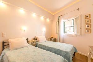 A bed or beds in a room at Lakka Seaview Apartments by Konnect