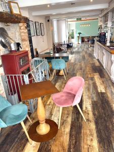 a restaurant with chairs and tables in a room at Beach Green Hotel in Lancing