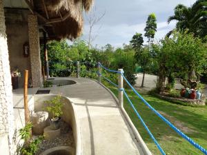 a path leading to a house with a blue rope at Sea Turtle House Moalboal in Moalboal