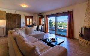 a living room with a large couch and a table at Villa Zeus in Kaloniktis