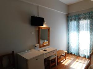 a bathroom with a sink and a mirror on the wall at Perdika Mare Guesthouse in Perdika