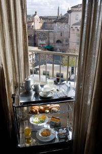 a breakfast table with food on a balcony with a view at Casa Montani in Rome