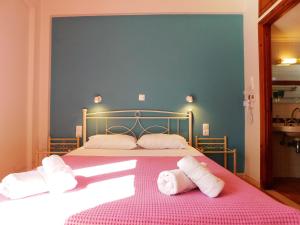 a bedroom with a bed with towels on it at Perdika Mare Guesthouse in Perdika
