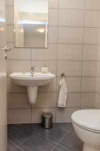 a bathroom with a sink and a toilet at Lovely 3BD flat with PARKING and SEA VIEW by Flаt Manаger in Chernomorets +37 photos