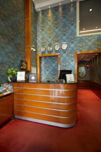 a lobby with a cash counter and clocks on the wall at Polatdemir Hotel in Istanbul