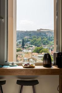 a table with a glass of water on top of it at Ciel Living Athens in Athens