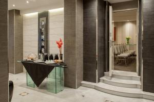 a lobby with a table with vases on it at Hotel Ariston in Rome