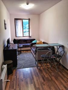 a living room with a table and a couch at Double Studio near SKI Lift - Bansko in Bansko