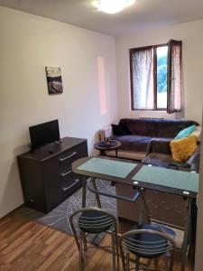 a living room with a couch and a table and chairs at Double Studio near SKI Lift - Bansko in Bansko