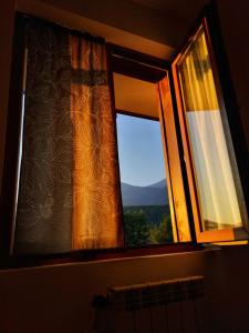 a window with a view of a mountain at Double Studio near SKI Lift - Bansko in Bansko +2 photos