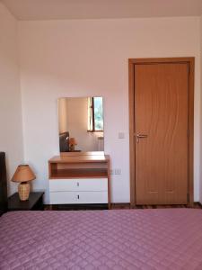 a bedroom with a bed and a desk and a door at Double Studio near SKI Lift - Bansko in Bansko