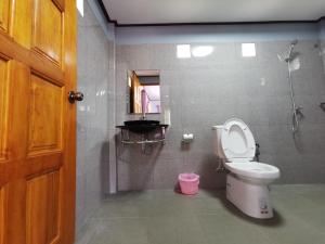 a bathroom with a toilet and a shower and a door at Walk in homestay in Ko Kood