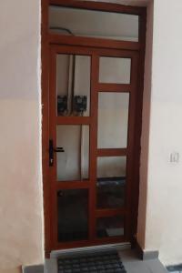 a wooden door with a window in a room at APARTMENT POPS in Cluj-Napoca