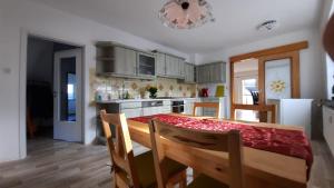 a kitchen with a table with chairs and a dining room at Ferienwohnung Rolf in Crottendorf