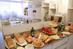 a kitchen counter with many different types of food at Boutique Hotel Casa Teatro in Manaus