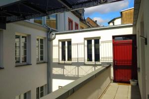 an alley between two buildings with red doors at Pearl Studio Apart - King Bed - Netflix - Projector - Fast Wi-Fi in Trier