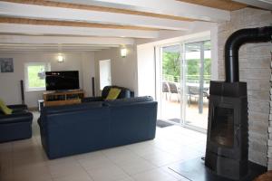 a living room with a couch and a fireplace at La Parenthèse Vosgienne in Bussang