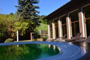 una piscina frente a una casa en Hotel Olivia Medical SPA, en Skomielna Czarna