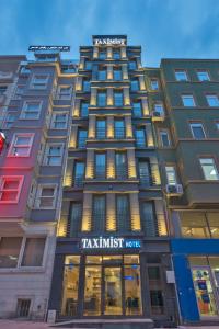 a tall building with a sign on the front of it at Taximist Hotel in Istanbul