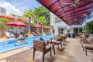 a pool with chairs and tables and umbrellas at Anik Boutique Hotel & Spa on Norodom Blvd in Phnom Penh