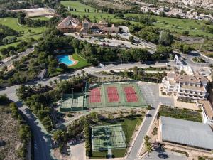 a large building with a lot of trees at Hotel Golf Campoamor in Dehesa de Campoamor