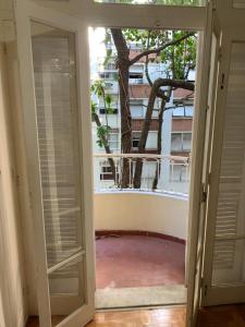 una puerta abierta a un balcón con un árbol en Copacabana, Sol e Mar, en Río de Janeiro