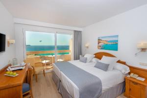 a hotel room with a bed and a view of the ocean at Valentin Reina Paguera - Adults Only in Paguera