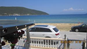 a white car parked next to the beach at Peramos Rent House in Néa Péramos +221 photos