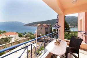 a balcony with a view of the water at Natassa Apartments in Ayia Evfimia