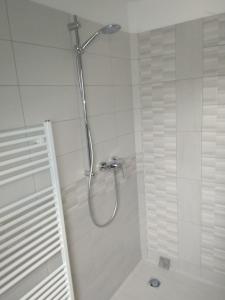 a shower with a shower head in a bathroom at APARTMÁNY NA VÝSLUNÍ in Horní Maxov