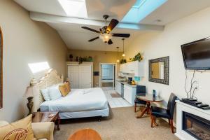 a living room with a bed and a kitchen at Sandals Inn | Spa Suite & Oceanside Cabana in Cannon Beach