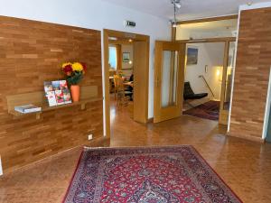 a living room filled with furniture and a door at Hotel Engl in Innsbruck