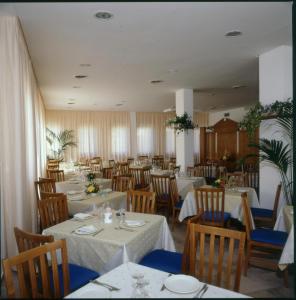 a dining room table with chairs and tables at Hotel Sirenetta in Isola delle Femmine