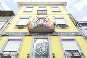 a yellow building with a sign on it at Pensao Central in Matosinhos
