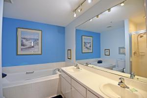 a bathroom with two sinks and a large mirror at Beach Front and Walking Distance to Village in Siesta Key +31 photos